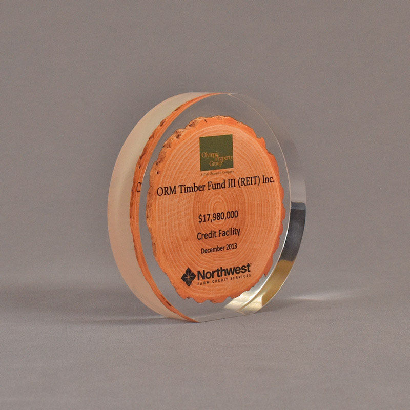 Round acrylic embedment deal toy with printed cross section of a tree trunk on paper cast inside Lucite®